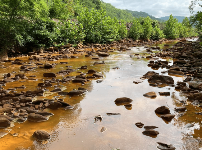 Pictured is the lower portion of Deckers Creek looking upstream to the former Richard Mine, which has left behind a legacy of degraded water quality throughout the creek. But a new planned acid mine drainage treatment system promises to clean up this stretch of the creek in Monongalia County.